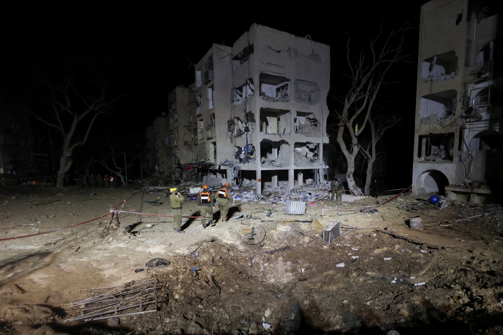 Israeli soldiers work at the scene of damage after Iranian missile barrages struck residential buildings in Arad, amid the US-Israel conflict with Iran, in southern Israel, March 22, 2026. — Reuters pic  
