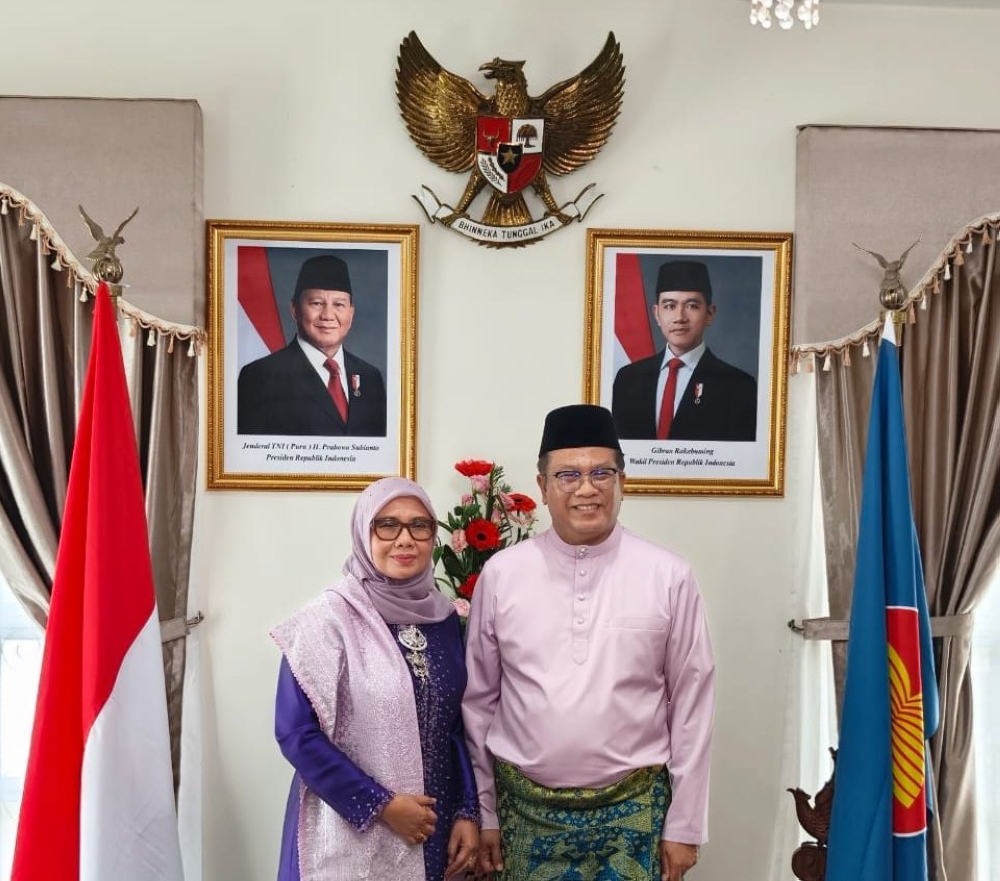 Abdullah, with his wife Irma Zulkifli, poses for a picture during a Raya gathering at their official residence here. – The Borneo Post pic