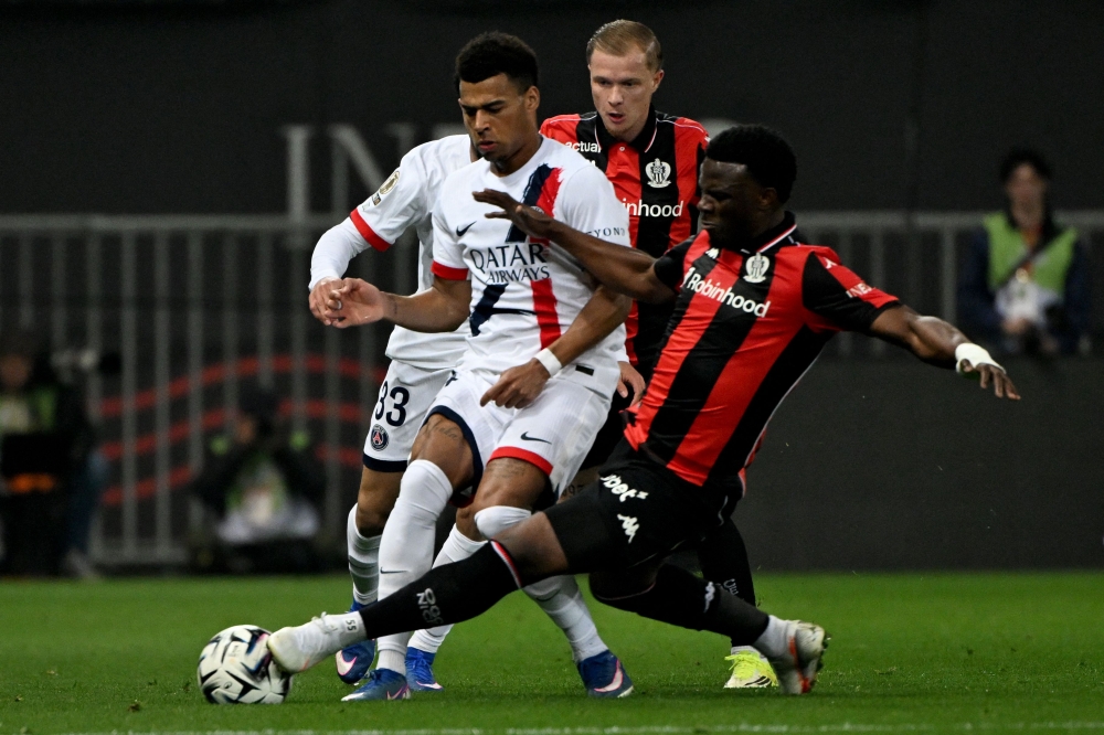 Paris Saint-Germain's French midfielder #14 Desire Doue (left) vies with Nice's Burundian defender #55 Youssouf Ndayishimiye (right) during the French L1 football match between OGC Nice and Paris Saint-Germain at the Allianz Riviera stadium in Nice March 21, 2026. — AFP pic 