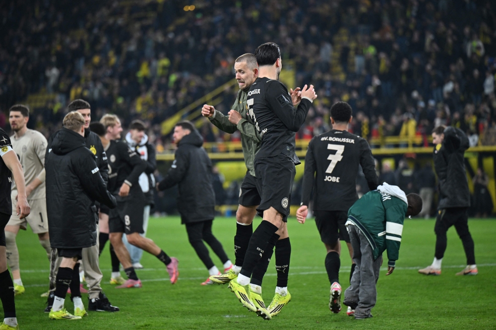 Dortmund's German defender #03 Waldemar Anton (Back) and Dortmund's Algerian defender #05 Ramy Bensebaini (front) celebrate after the German first division Bundesliga football match between Borussia Dortmund and HSV Hamburg in Dortmund March 21, 2026. — AFP pic