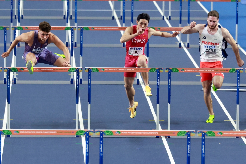 (From left) USA's Trey Cunningham, China's Junxi Liu and France's Romain Lecoeur compete in the men's 60m hurdles semi-final heat 2 during the World Athletics Indoor Championships Kujawy Pomorze 2026 in Torun, Poland March 21, 2026. — AFP pic 