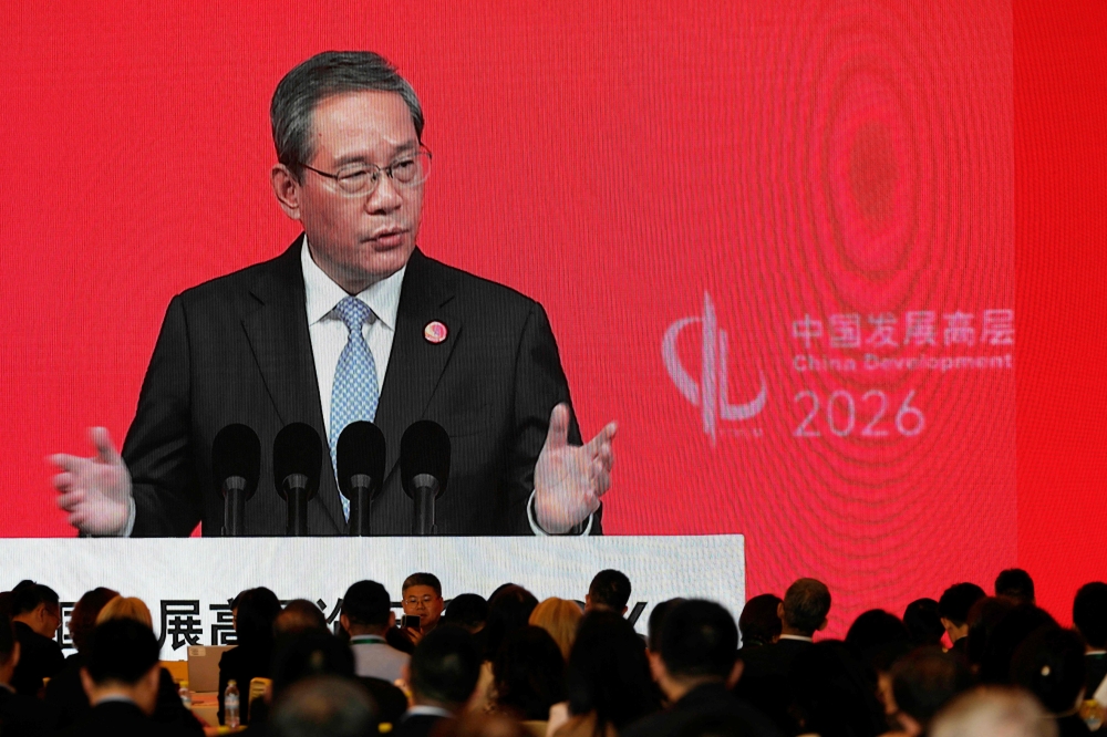 Chinese Premier Li Qiang is seen on a big screen live broadcasting his speech at the opening of the China Development Forum 2026 held at the Diaoyutai State Guesthouse in Beijing March 22, 2026. — Ng Han Guan/Pool/AFP pic 