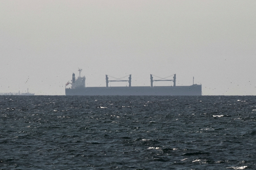 A cargo ship in the Gulf, near the Strait of Hormuz, as seen from northern Ras al-Khaimah, near the border with Oman’s Musandam governance, amid the US-Israeli conflict with Iran, in United Arab Emirates, March 11, 2026. — Reuters/Stringer pic