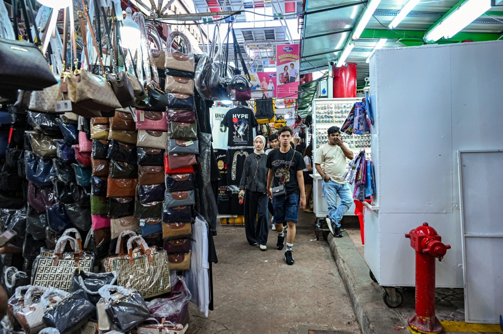 Locals and tourists alike are drawn to Petaling Street’s bustling stalls, where imitation ‘copy ori’ goods remain a popular pick. — Bernama pic