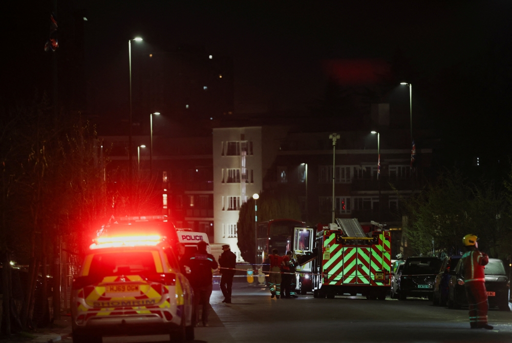 Emergency personnel work near the scene after four ambulances belonging to Hatzola, a Jewish community organisation, were set on fire in an incident that the police say is being treated as an antisemitic hate crime, in northwest London, Britain, March 23, 2026. — Reuters pic