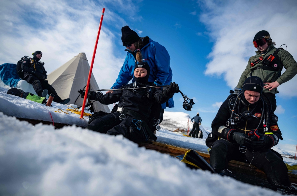 Participants in the Polar Scientific Diving program prepare for a 45-minute-long diving session, at the Kilpisjaervi Biological Station in Finland on March 14, 2026. — AFP pic