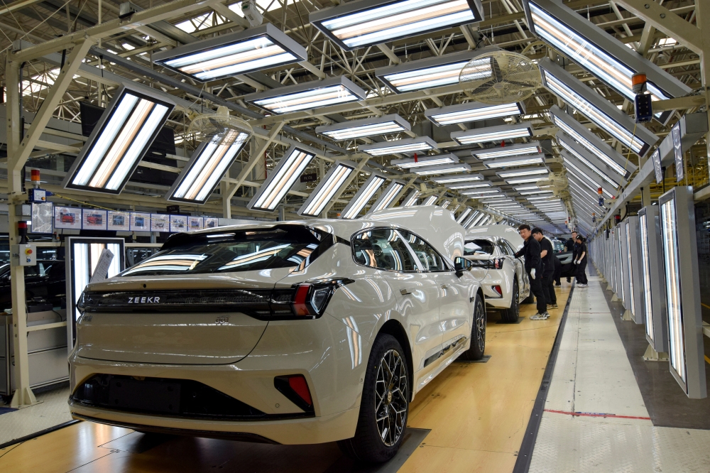 Workers inspect finished Zeekr 001 electric cars at Zeekr’s factory in Ningbo, China, April 20, 2025. — Reuters pic