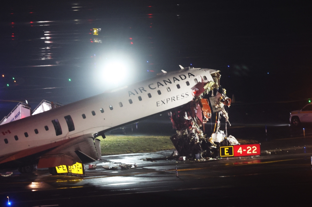 An Air Canada Express plane sits on the tarmac after it collided with a fire truck on the tarmac at LaGuardia Airport on March 23, 2026 in New York City. — AFP pic