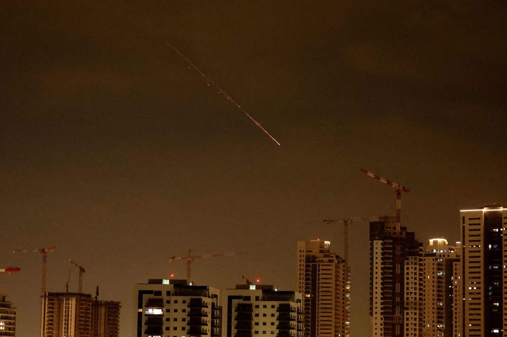 Rocket trails are seen in the sky amid a fresh barrage of Iranian missile attacks above the Israeli coastal city of Netanya on March 23, 2026. — AFP pic