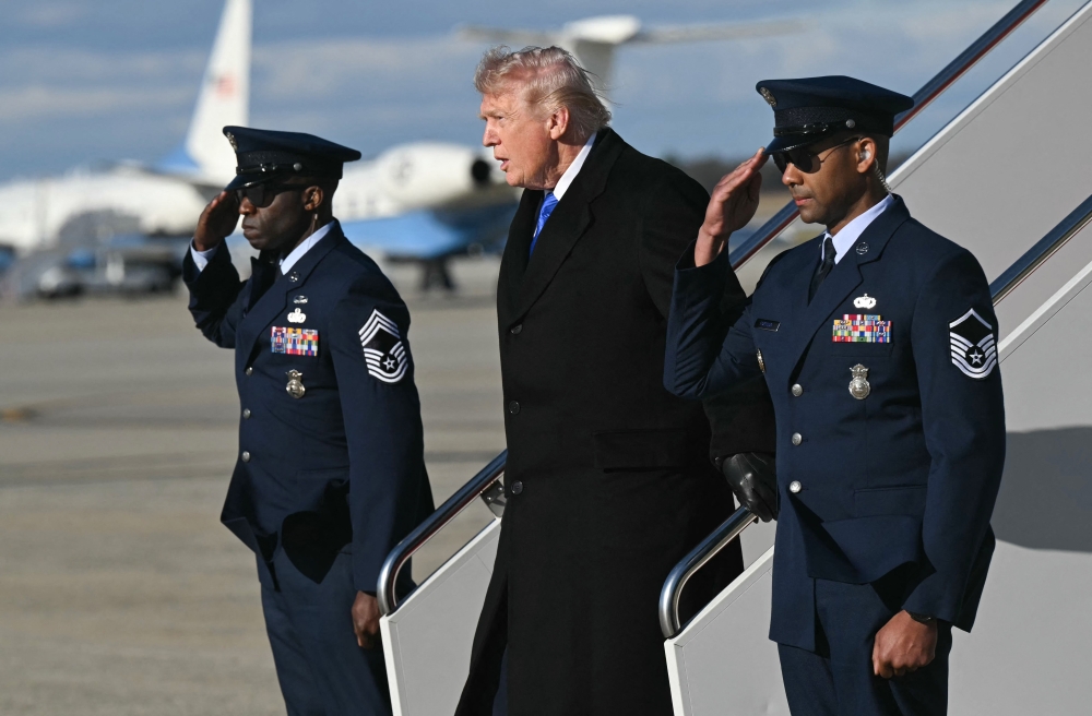 US President Donald Trump disembarks from Air Force One upon arrival at Joint Base Andrews in Maryland, March 23, 2026. — AFP pic
