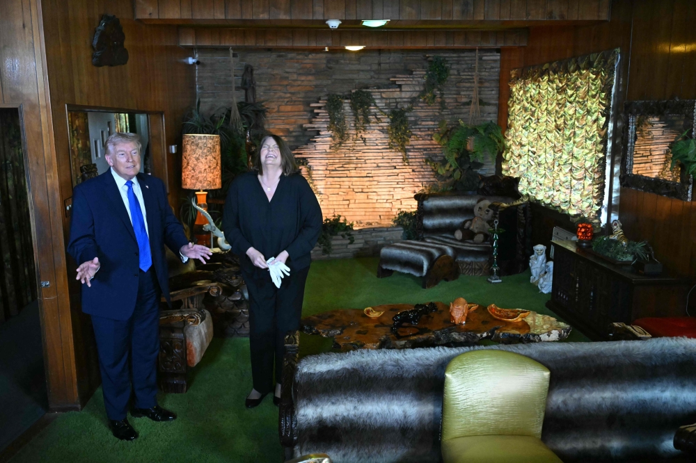 US President Donald Trump tours the Jungle Room of Graceland, the estate of Elvis Presley, accompanied by Angie Marchese, vice president of Graceland’s Archives and Exhibits, in Memphis, Tennessee, March 23, 2026. — AFP pic