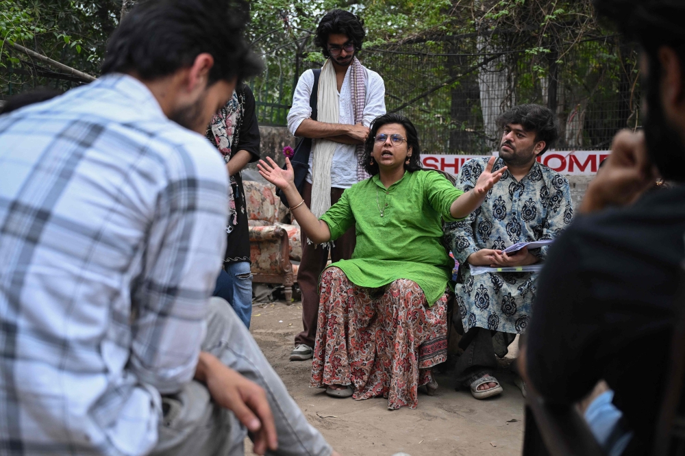 Activist Ritu (left) and PhD scholar Vaibhav Das, who identify as non-binary, interact with students on the proposed Transgender Persons (Protection of Rights) Amendment Bill in New Delhi March 18, 2026. — AFP pic