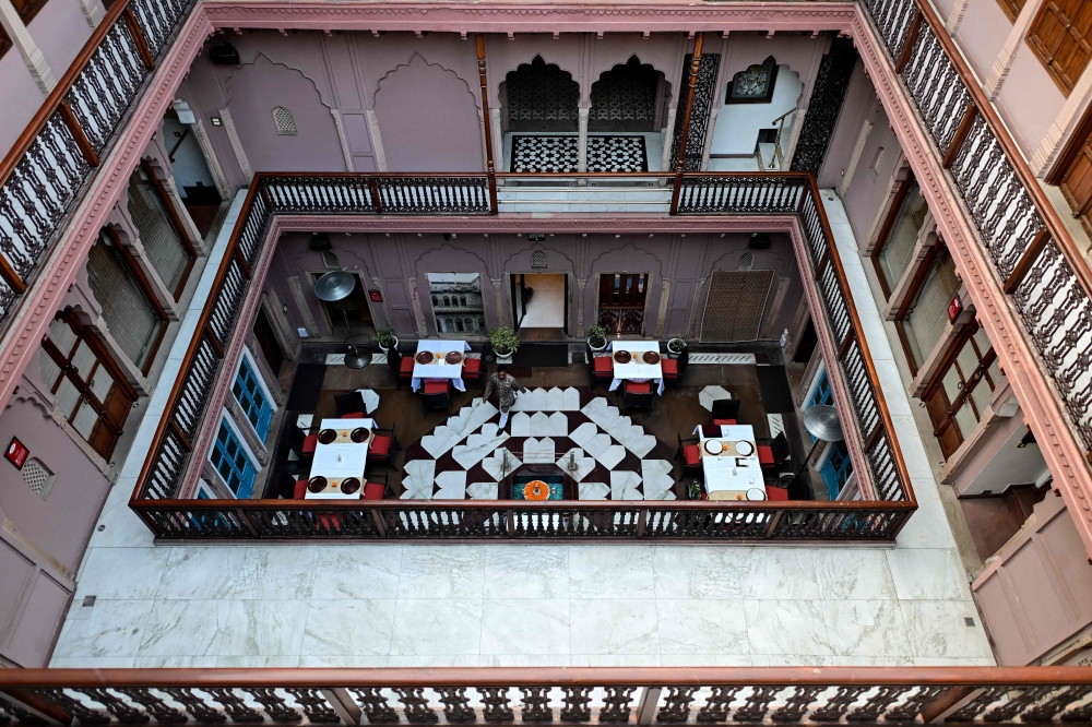 This photograph taken on February 2, 2026 shows a hospitality staff walking across a courtyard of the Dharampura Haveli, an 18th-century haveli-turned-heritage hotel in the old quarters of Delhi. — AFP pic