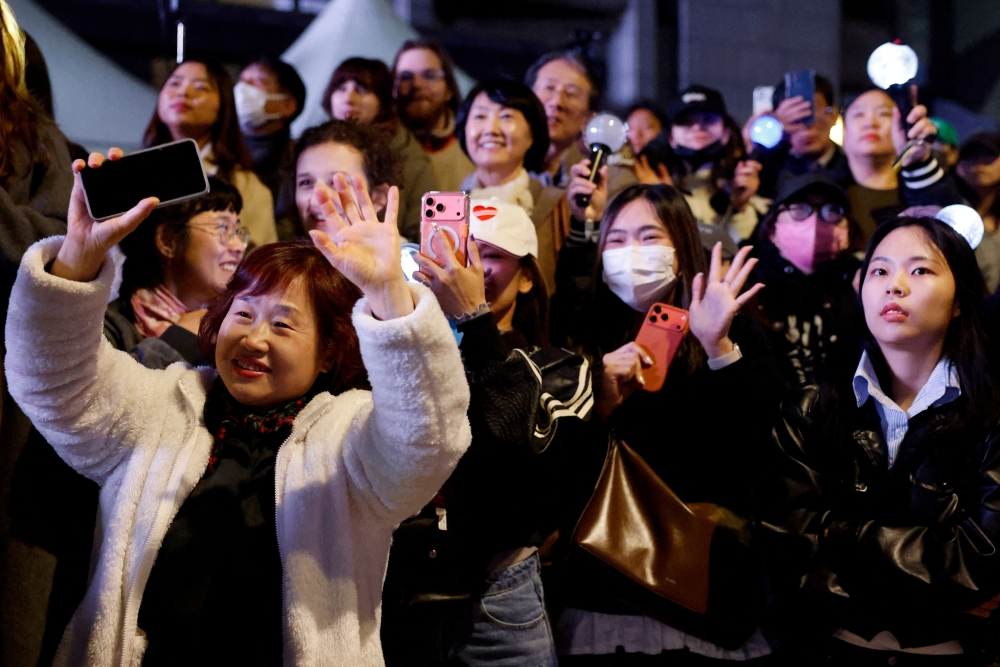 Fans of Kpop group BTS react on the day of the ‘BTS The Comeback Live Arirang’ concert in central Seoul March 21, 2026. — Reuters pic