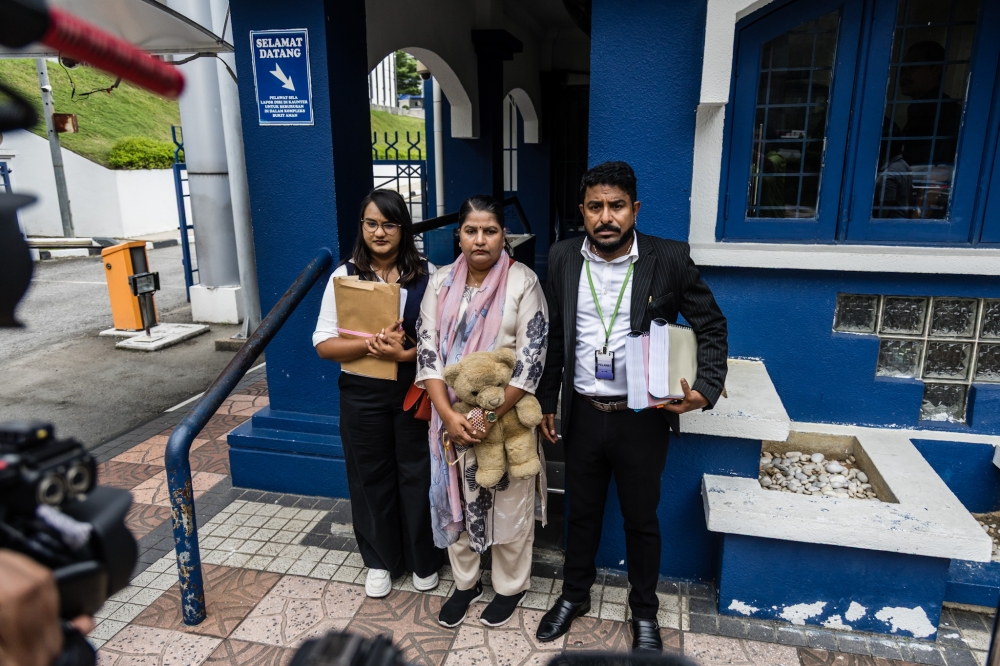 Indira Gandhi (centre) and Indira Gandhi Action Team (Ingat) chairman Arun Dorasamy (right) are seen before the meeting with IGP Tan Sri Mohd Khalid Ismail at the Bukit Aman police headquarters in Kuala Lumpur December 10, 2025. — Picture by Firdaus Latif