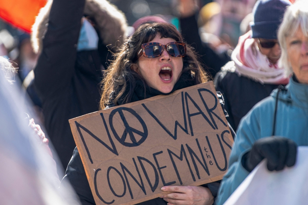 A demonstrator yells slogans while protesting against the United States and Israel for initiating the Middle East war in Montreal. Diplomatic efforts between the US and Iran show tentative progress, even as violence continues across the region. — AFP pic