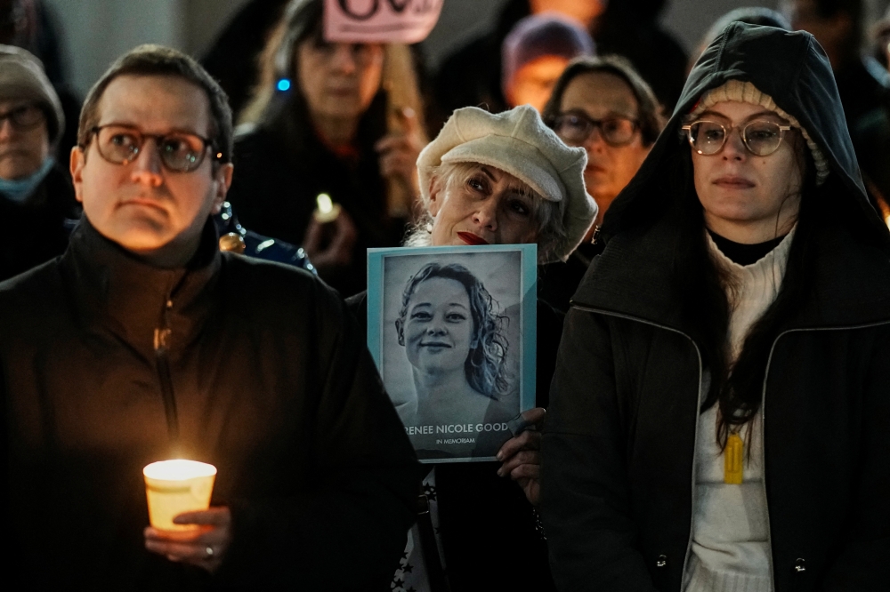 A person holds a picture of Renee Good as people attend a vigil after a US immigration agent shot and killed the 37-year-old in her car in Minneapolis, in New York January 9, 2026. — Reuters pic 