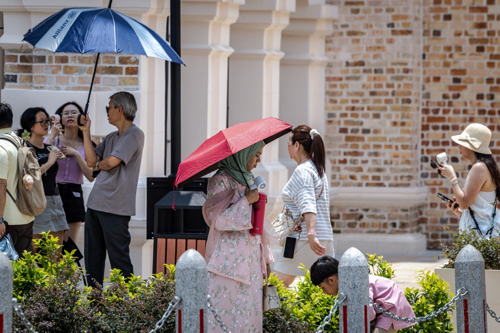 MOH reminds the public to take preventive measures, including planning outdoor activities such as Raya pilgrimages by avoiding peak heat hours between 11am and 4pm. — Picture by Firdaus Latif