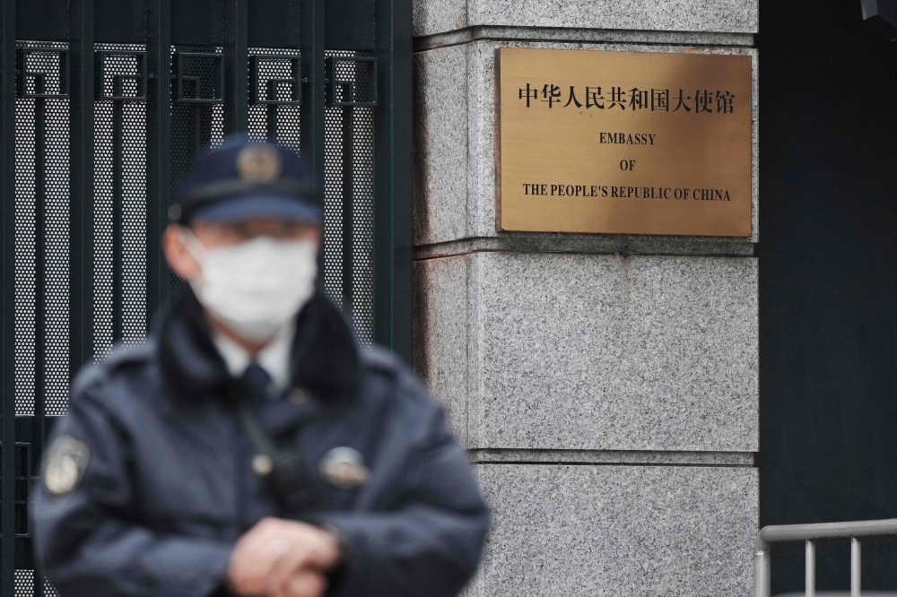 A policeman stands guard at an entrance to the Chinese embassy in Tokyo March 25, 2026. — AFP pic