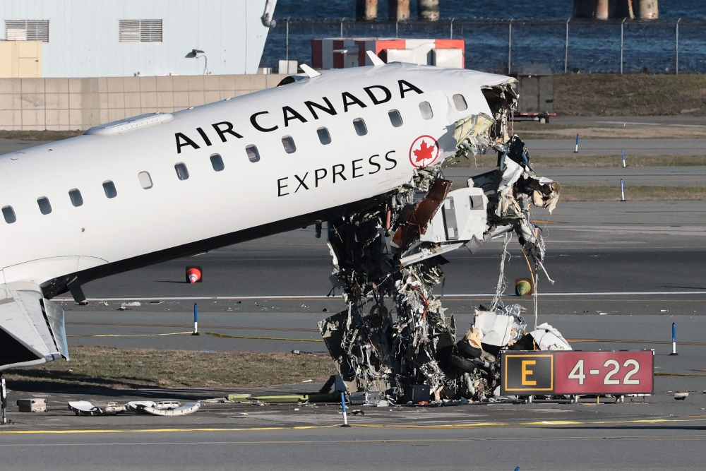 An Air Canada Express CRJ-900 sits on the runway after colliding with a Port Authority fire truck at LaGuardia Airport in New York March 24, 2026. — AFP pic 