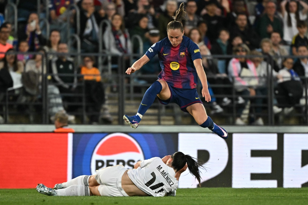Barcelona’s Clara Serrajordi jumps over Real Madrid’s Maria Mendez during their Uefa Women’s Champions League quarter-final first leg match at the Alfredo Di Stefano stadium in Madrid March 25, 2026. — AFP pic