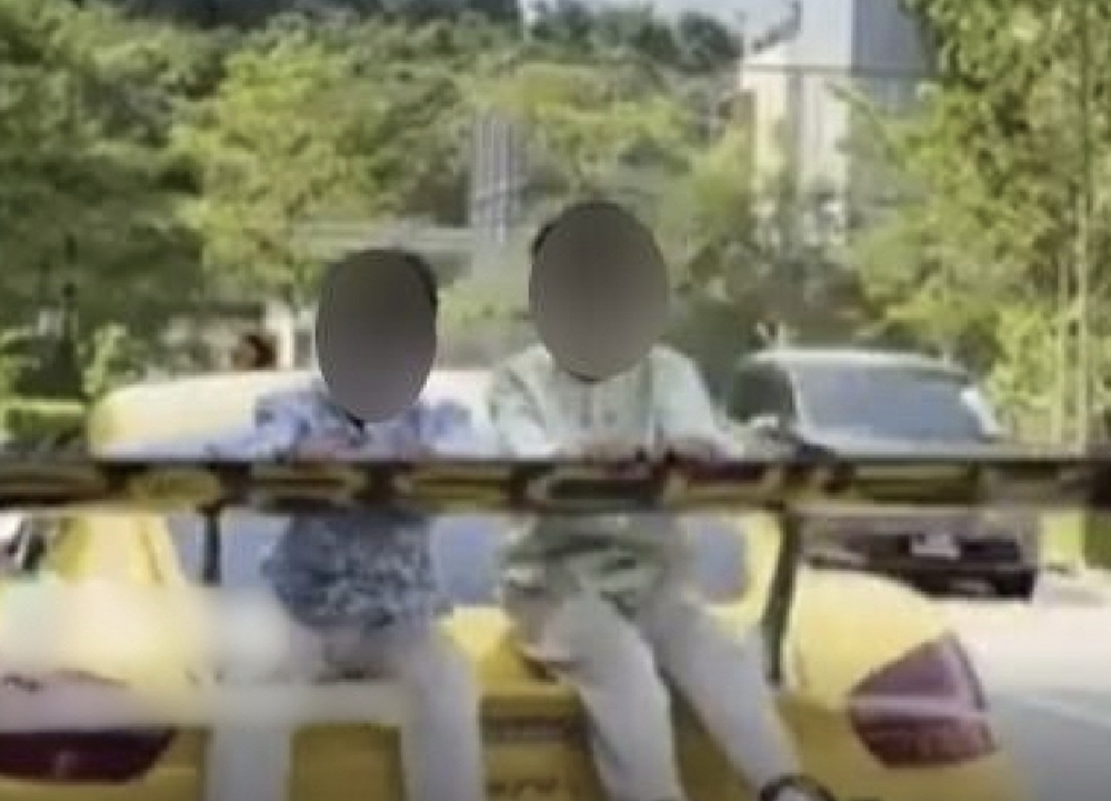 A man has been charged in Singapore after allegedly driving with two young children seated on a car boot, an incident that circulated widely on social media. — Screengrab from TikTok