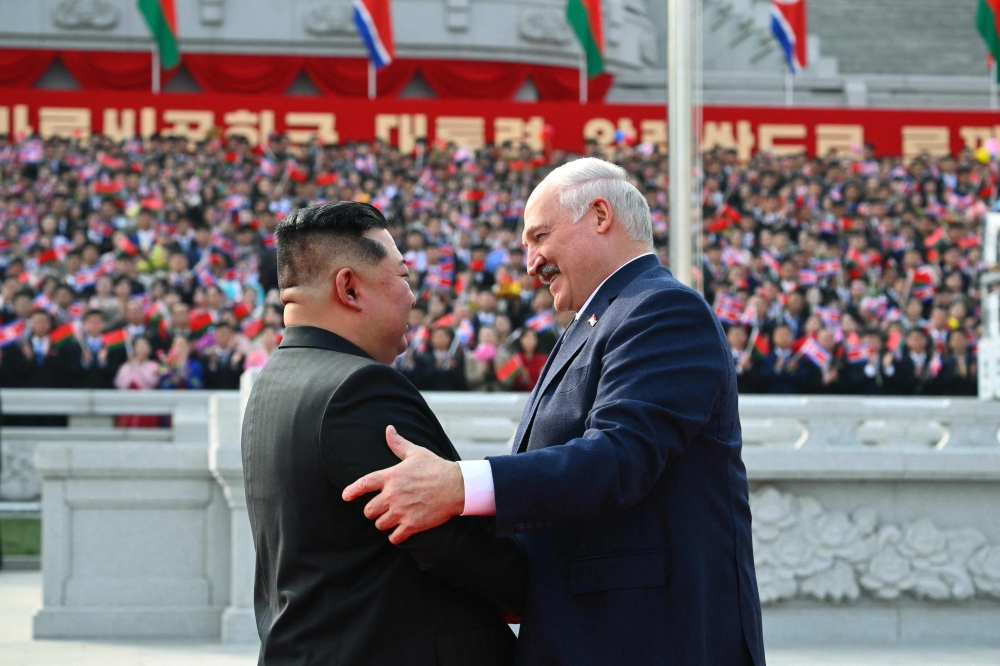 In this handout picture taken and released by the Belarusian presidential press service on March 25, 2026, Belarus’ President Alexander Lukashenko and North Korean leader Kim Jong Un greet each other during a welcoming ceremony prior to their talks in Pyongyang. — Handout via AFP