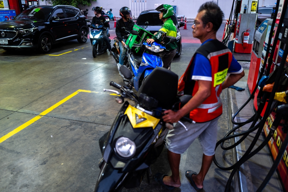 People with vehicles queue to fill up fuel at a gas station amid the US-Israeli conflict with Iran, in Bangkok March 26, 2026. — Reuters pic