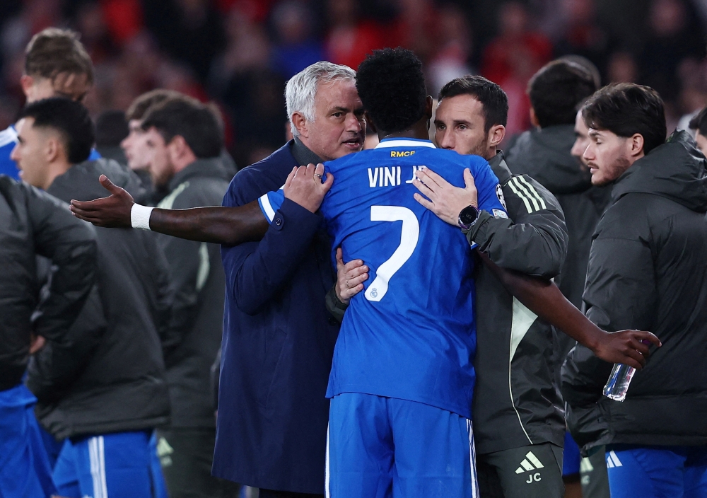 Real Madrid’s Vinicius Junior with Benfica coach Jose Mourinho at Estadio da Luz in Lisbon February 17, 2026, as their Uefa Champions League first-leg match was stopped due to racist chants. — Reuters pic
