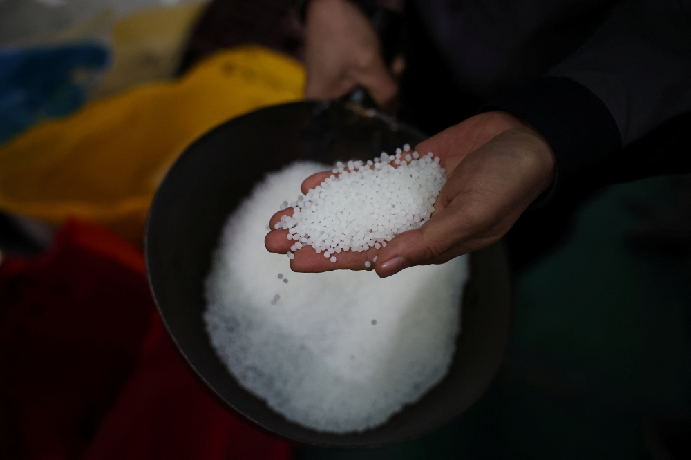 An official from a plastic film factory shows polyethylene, in Ansan. South Korea is tightening exports of naphtha — a key oil-derived feedstock used in petrochemicals and plastics — to protect domestic supply. — Reuters pic 