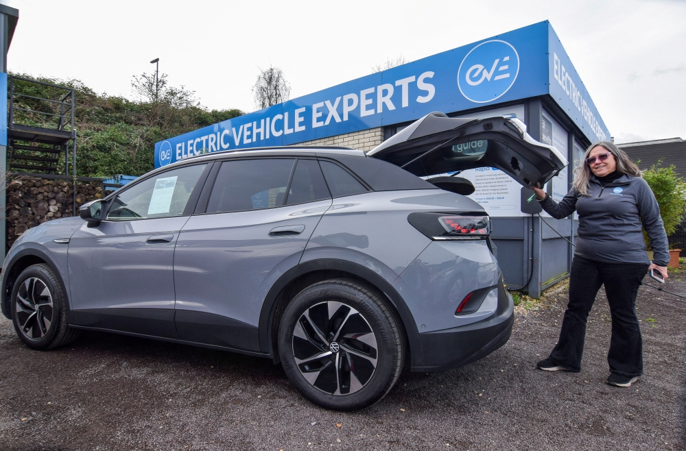 Estelle Miller, co-owner of used electric car dealership EV Experts, inspects vehicles in their inventory in Guildford. Online car platforms report rising searches and sales of EVs amid higher fuel costs linked to the Middle East conflict. — Reuters pic