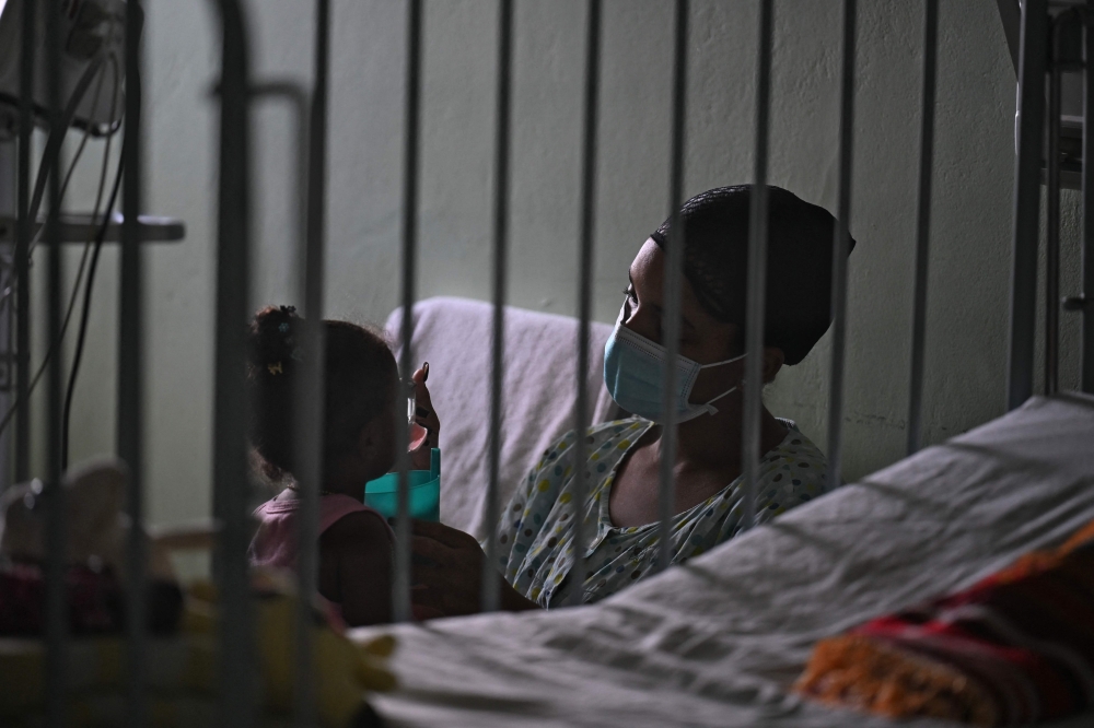 A woman cares for her daughter at the William Soler Pediatric Cardiocenter in Havana on March 24, 2026. — AFP pic