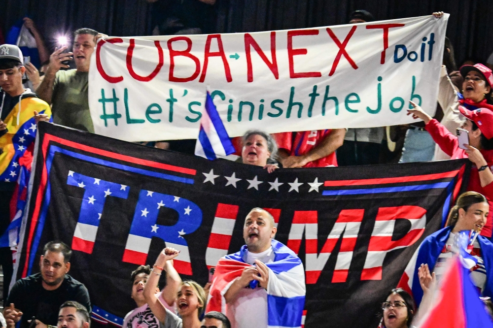 People hold Cuban flags and a flag supporting US President Donald Trump while participating in the “Cuba Libre” demonstration in the city of Hialeah, Florida on March 24, 2026. — AFP pic
