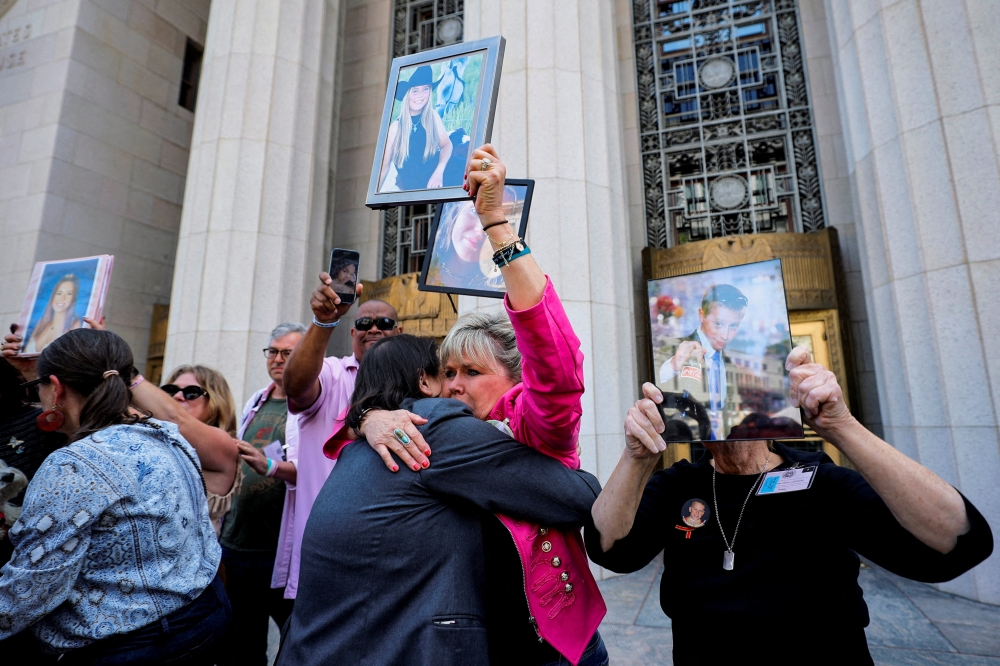Lori Schott, the mother of Annalee, is embraced by lawyer Laura Marquez-Garrett outside the court after a jury finds Meta and Google liable in a key test case accusing Meta and Google’s YouTube of harming children’s mental health through addictive social media platforms in Los Angeles, California on March 25, 2026. — Reuters pic