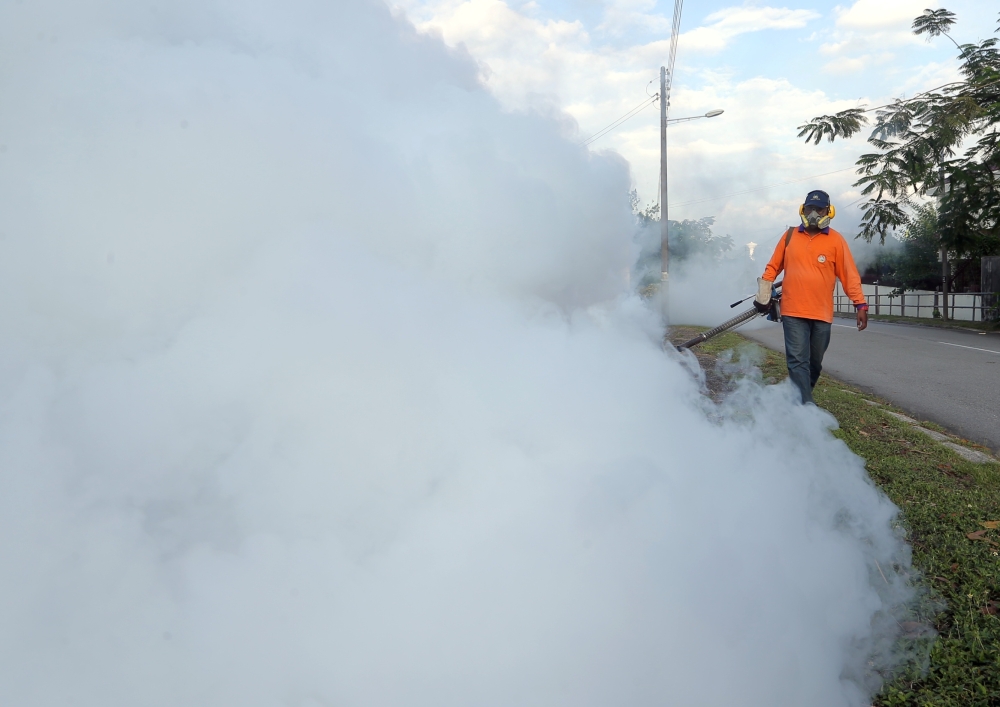 Ipoh City Council workers are seen fogging drains in Taman Meru, Ipoh on March 27, 2018. — Picture by Farhan Najib