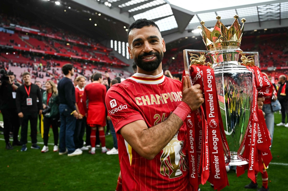 Liverpool’s Mohamed Salah celebrates with the Premier League trophy at the end of the Premier League match with Crystal Palace at Anfield in Liverpool May 25, 2025. — AFP pic