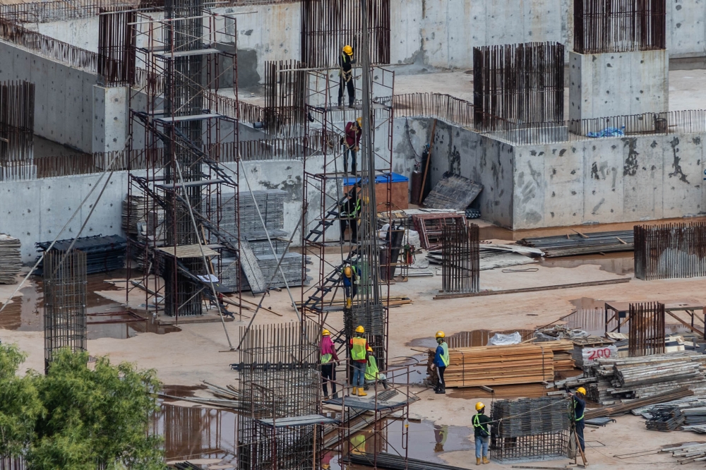 Workers are seen at a construction site in Kuala Lumpur on August 5, 2025. — Picture by Firdaus Latif