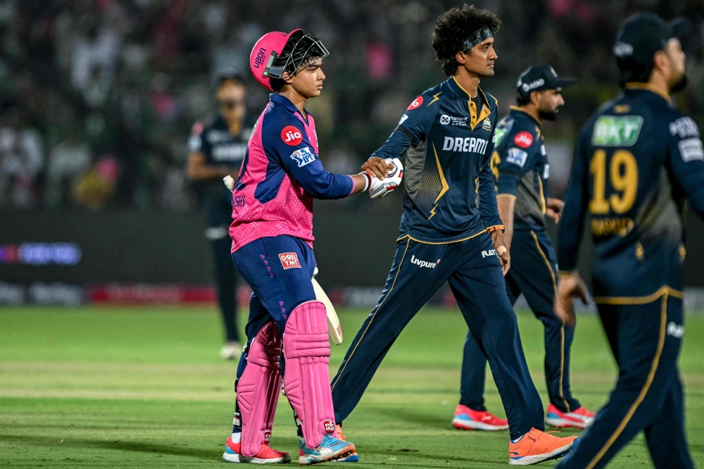 Rajasthan Royals’ Vaibhav Suryavanshi (left) is being greeted by Gujarat titans’ players as he walks back to the pavilion after his dismissal during the Indian Premier League Twenty20 cricket match between Rajasthan Royals and Gujarat Titans at the Sawai Mansingh Stadium in Jaipur on April 28, 2025. — AFP pic