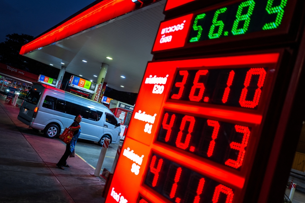 A woman looks at a fuel price board in front of a gas station amid the US-Israeli conflict with Iran, in Bangkok March 26, 2026. — Reuters pic 