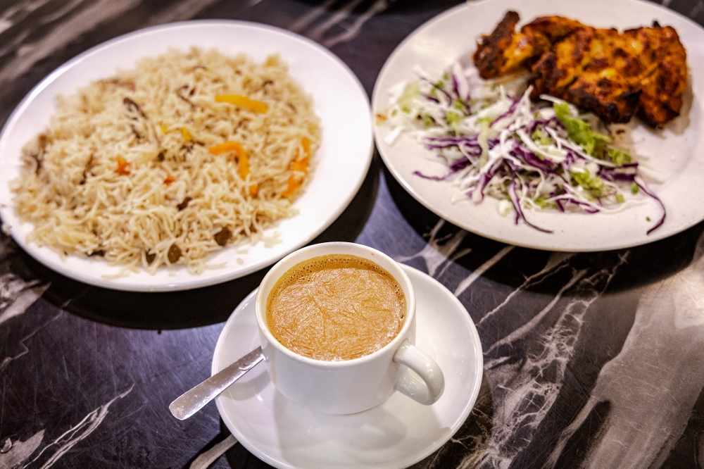 Signature dishes at Khan Jee include Pulao rice, BBQ chicken, and flavorful masala tea. — Picture by Firdaus Latiff