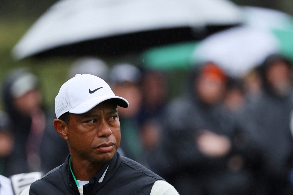 Tiger Woods’ turbulent career veered into fresh turmoil yesterday when the golf icon was arrested and charged with driving under the influence after a rollover crash near his Florida home, authorities said. — Reuters pic  