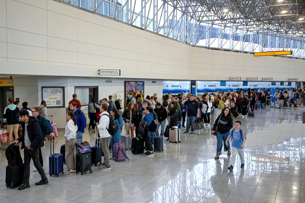 Passengers stand in the TSA line after the US Senate voted to end a partial government shutdown that has caused severe ‌delays at airports across the country, at Baltimore/Washington International Thurgood Marshall Airport (BWI), in Baltimore, Maryland March 27, 2026. — Reuters pic