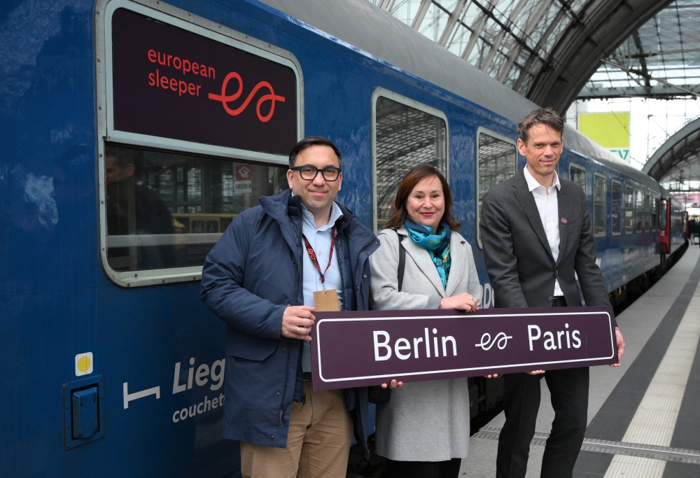 (From left) Co-founder of the ‘European Sleeper’ train, Elmer van Buuren, managing director of ‘Visit Berlin’ Sabine Wendt and co-founder of ‘European Sleeper’ Chris Engelsman stand with a sign after the arrival of the European Sleeper night train from Paris in Berlin, on March 27, 2026.  — AFP pic