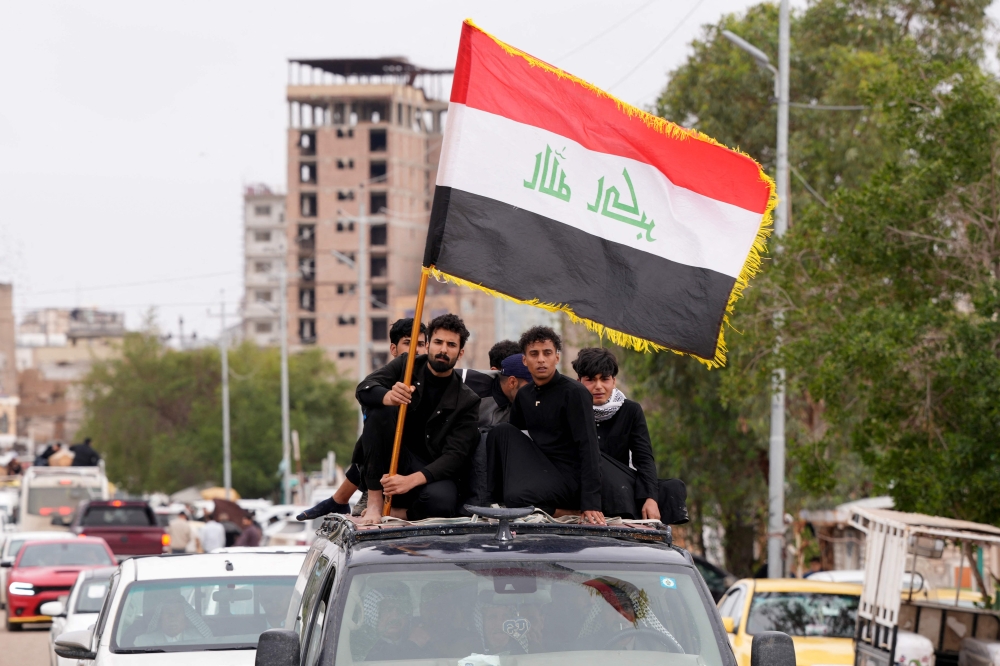 The coffin of Ahmed Al-Jubouri, a member of Iraq’s Ministry of Defence who was killed at the Habbaniyah military base following an aerial attack, is driven during his funeral to the Wadi al-Salam Cemetery in the southern city of Najaf on March 26, 2026. Iraq is extending its airspace closure till March 31, 2026 due to the US-Israel-Iran war that is spilling over to other countries in the Gulf region. — AFP pic