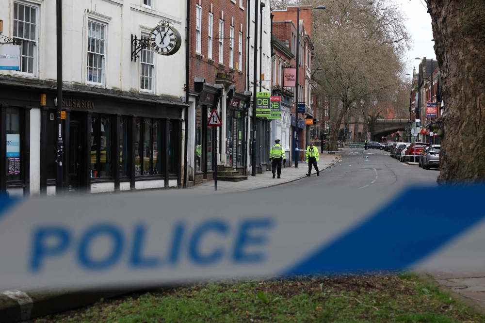 Police officers work inside a cordon set up on Friar Gate in Derby, central England on March 29, 2026, the day after a in his 30s man drove his Suzuki Swift car into a crowd of pedestrians, injuring seven people. — AFP pic