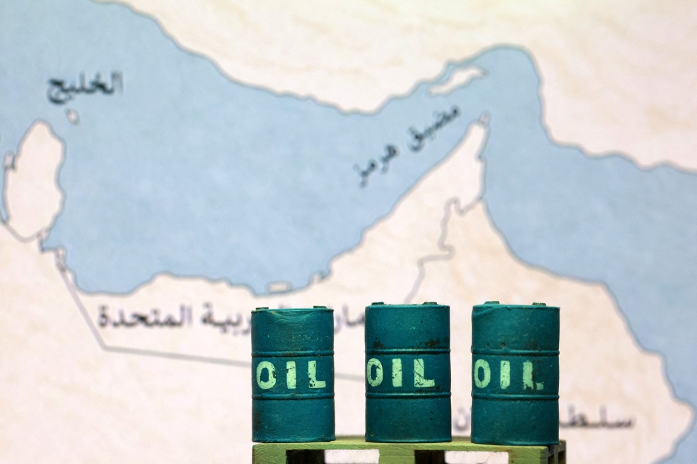 A map showing the Strait of Hormuz, also known as Madiq Hurmuz, and 3D printed oil barrels are seen in this illustration taken March 26, 2026. — Reuters pic 