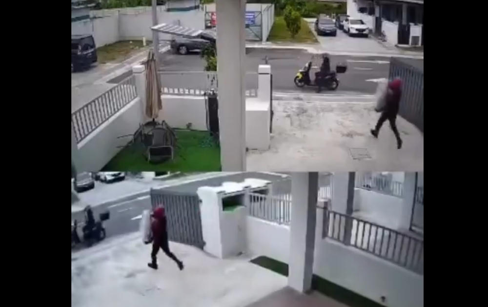 CCTV footage showed a man and a woman arriving on a motorcycle and stopping in front of a house with its main gate open. The man then dismounted, took a parcel from the compound, and fled the scene with the woman. — Screengrab from X/@update11111