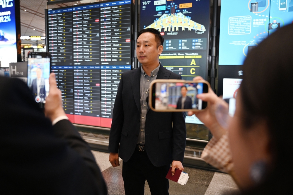 Zhao Bin, a Chinese business traveller, speaks to media after checking in for a flight to Pyongyang, North Korea, at Beijing airport on March 30, 2026. Air China restarted direct flights between Beijing and Pyongyang today after a six-year hiatus, another sign isolated North Korea is gradually opening up following the resumption of train services between the capitals. — AFP pic 