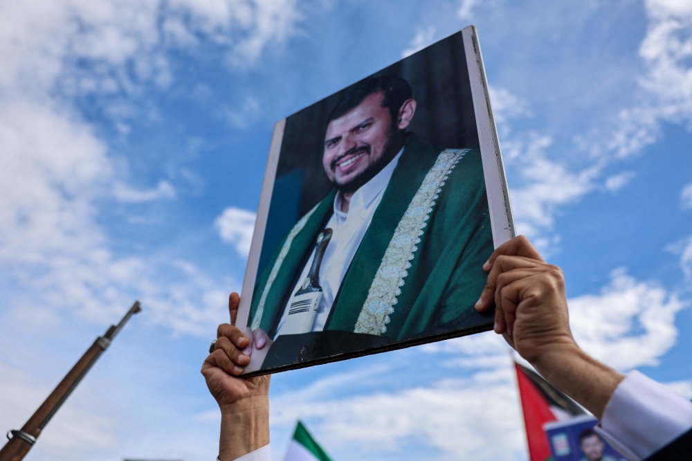 A Houthi supporter holds up a poster with an image of the Houthi movement’s leader, Abdul-Malik al-Houthi during demonstration in solidarity with Iran, as the US-Israeli conflict with Iran continues, in Sanaa, Yemen, March 27, 2026. — Reuters pic