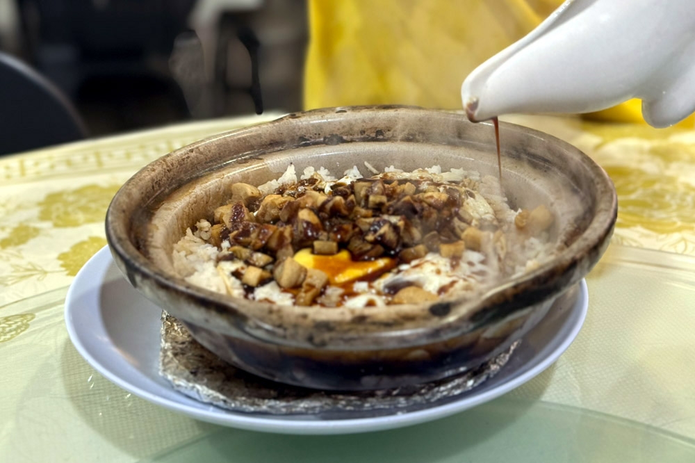 First pour the sauce over the rice. — Picture by CK Lim